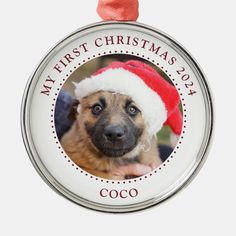 a christmas ornament with a dog wearing a santa hat