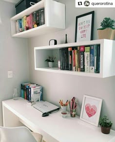 a white desk topped with lots of books next to a wall mounted shelf filled with books