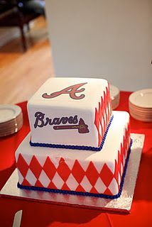 two tiered cake with the word braves on it sitting on top of a table