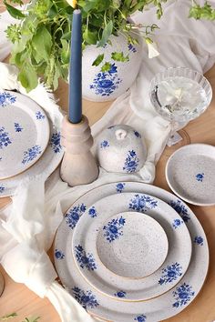 a blue and white dinner set on a wooden table