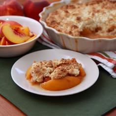 peach cobbler on a plate next to a bowl of peaches and a dish of pie