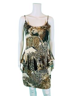 A fun vintage 1980s/90s lion & tigers animal print dress with spaghetti straps, scoop neck, dropped peplum waist and mini length. Dress pulls over and has no closures. LABEL: Fit-Knit MARKED VINTAGE SIZE: M FABRIC: 65% Polyester, 35% Cotton BUST: 34" WAIST: 31" HIPS: 35" LENGTH: 36" CONDITION: great, has light pilling at underarms PINNED TO MODEL?: no ☝For reference Mod's measurements are S 11", B 32.5", W 24", H 32.5"☝ [EE1521] ♪ Gonna dress you up in Storyland Vintage, all over, all over ♪ htt Brown Sleeveless Tiger Print Dress, Summer Tiger Print Mini Dress, Leopard Print V-neck Mini Dress For Day Out, Tiger Print Mini Dress, Chic Leopard Print V-neck Mini Dress, Pet Tiger, Animal Print Dresses, Dress Clothes For Women, Scoop Neck