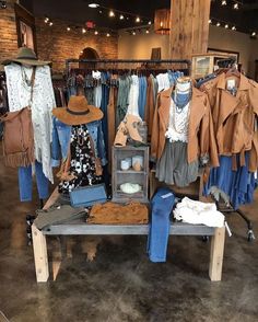 clothes and hats are on display in a clothing store