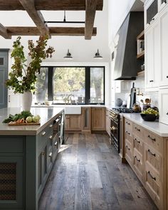 a kitchen with wooden floors and white walls