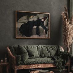 a living room filled with furniture and a painting hanging on the wall above it's head