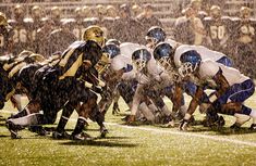 a football game is being played in the rain