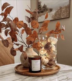 a candle and some leaves on a table