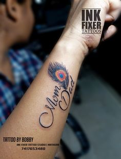 a man with a tattoo on his arm that reads ink fixer tattoos, written in cursive writing