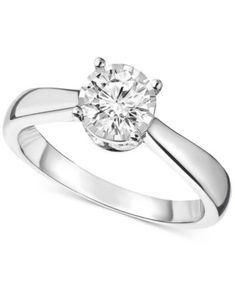 a white gold engagement ring with a round diamond