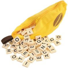 a banana and some letters in front of a yellow bag with words written on it