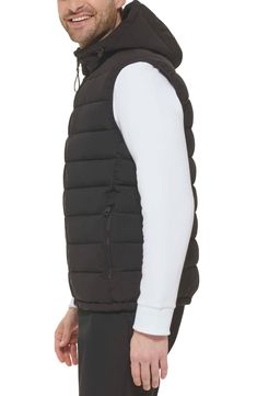 Easy to layer, this puffer-style vest features an attached hood that furthers the comfort. Attached hood Sleeveless 100% polyester Machine wash Imported Model stats: 6'1" height, 32" waist. Model is wearing size M. Fitted Nylon Vest For Cold Weather, Fitted Nylon Puffer Jacket For Outdoor Activities, Black Sporty Puffer Vest, Sleeveless Black Puffer Jacket For Fall, Sleeveless Black Down Outerwear, Down Vest With Padded Collar, Sporty Nylon Vest For Winter, Sleeveless Down Vest With Padded Collar, Fitted Nylon Vest Outerwear