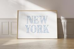 an empty room with a framed new york poster