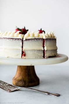 a cake with white frosting and strawberries on top