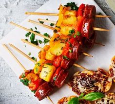 several skewered food items on a white plate