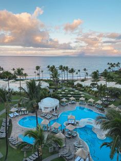 an aerial view of a resort pool and beach