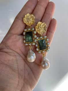 SALE $30 off Originally listed at $159.95 now $129.95 Labradorite Gemstone and baroque pearl statement earrings ina large gold floral stud finding This handmade Baroque Pearl earrings is a statement piece! The Baroque flameball cultured pearls are medium size, measures 15mm x 30mm approx, white, lustrous, AAA quality, attached to a gorgeous genuine labradorite stone with pearl connector. The finding is a beautiful gold floral stud with cz stones. Comes with sturdy push lock, gold plated, to supp Unique Bridal Earrings, Ethereal Jewelry, Pearl Statement Earrings, Pearls Jewelry, Baroque Pearl Earrings, Labradorite Earrings, Dope Jewelry, Funky Jewelry