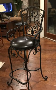 a black chair sitting on top of a hard wood floor