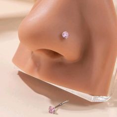 there is a fake nose with two small pink stones on it's tip,