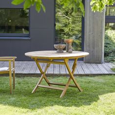 a table and two chairs sitting in the grass