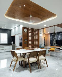 a modern dining room with white marble flooring and wooden accents on the ceiling is lit by recessed lights