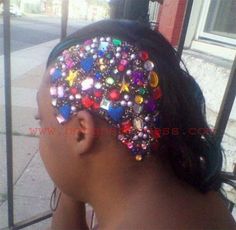 a close up of a person wearing a headband with beads and buttons on it