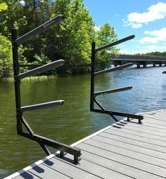 the metal railings are on the dock by the water