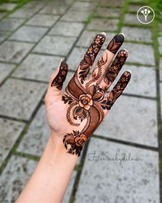 the hand is decorated with henna and flowers