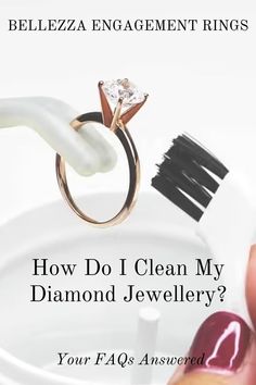 a woman's hand holding a diamond ring with the words how do i clean my diamond jewelry?