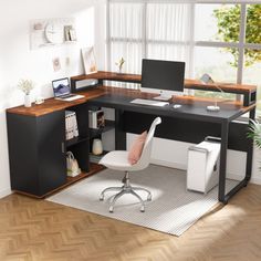 an office desk with a computer and chair in front of a large window on the floor