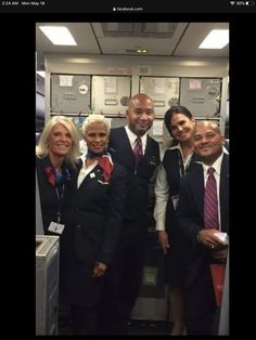 a group of people standing next to each other in front of lockers at an airport