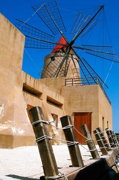 an old windmill sitting next to a building