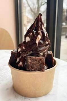 a bowl filled with brownies and marshmallows on top of a table