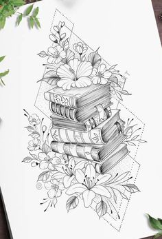 some books are stacked on top of each other with flowers and leaves in the background