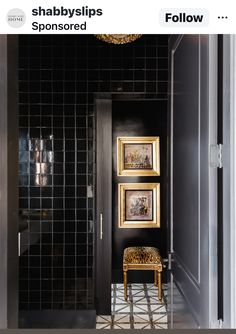 a black and gold bathroom with pictures on the wall