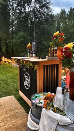 an outdoor bar with flowers and drinks on it