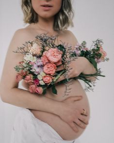 a pregnant woman with flowers on her stomach