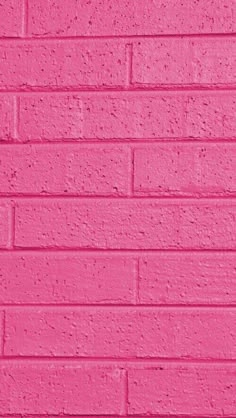 a pink brick wall painted in bright colors