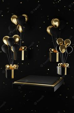 black and gold balloons floating in the air next to a table with presents on it