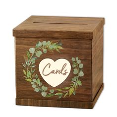 a wooden box with a heart and leaves painted on it