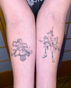 two people with tattoos on their legs