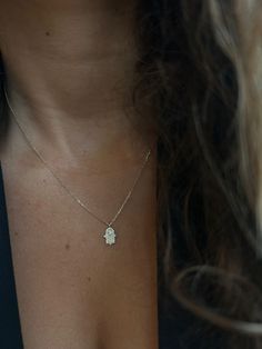 Elevate your style and embrace a touch of spirituality with our 14K Gold Hollow Hamsa Necklace. This captivating piece not only exudes timeless elegance but also carries a deep symbol of protection, bringing positive energy and good fortune into your life. ✨ Key Features ✨ Material: 14K Gold Chain Length:42 cm Diamond Carat Weight: 0.18 carats Diamond Clarity: SI (Slightly Included) Clasp Type: Lobster Clasp 🔸 Exquisite Craftsmanship 🔸 Crafted with utmost precision and attention to detail, thi Spiritual Gemstone Necklaces For Celebration, White Gold Spiritual Necklace With Gemstone, Spiritual White Gold Gemstone Necklace, White Gold Pendant Necklace Hand Set, Diamond Amulet Necklace For Gift, Spiritual 14k Gold Jewelry For Celebrations, Spiritual White Gold Necklace With Birthstone, Spiritual Yellow Gold Necklace For Celebration, Handmade 14k Gold Spiritual Necklace