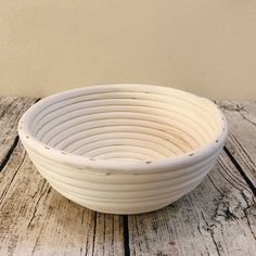 a white bowl sitting on top of a wooden table