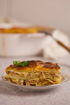 a plate that has some food on top of it and another dish in the background