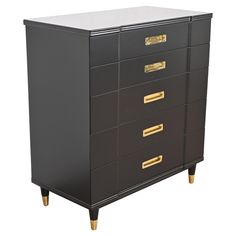 a black dresser with gold handles and drawers