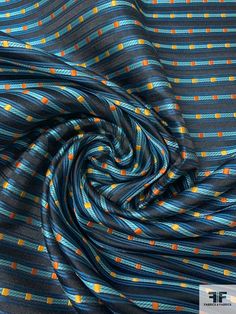 a blue and orange striped fabric with small yellow dots on the bottom half of it