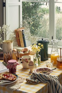 the table is set with breakfast food and drinks