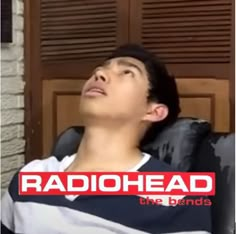 a man sitting in a chair with his head up and the words radiohead on it