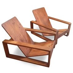 two wooden chairs sitting next to each other on top of a white surface with no one in it