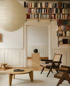 a living room filled with furniture and bookshelves