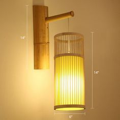 a wall light with a wooden arm and yellow shade on the side, next to a white wall